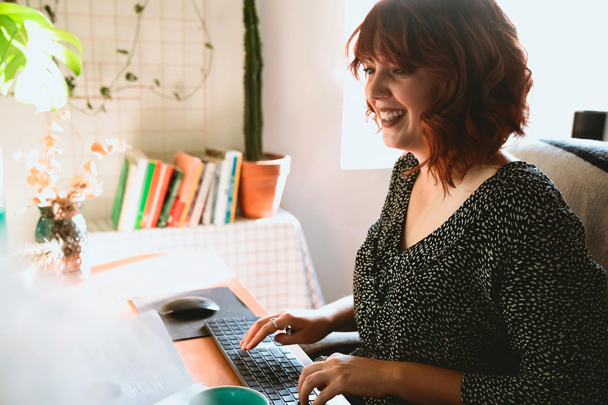 Woman smiling studying online in a home office
